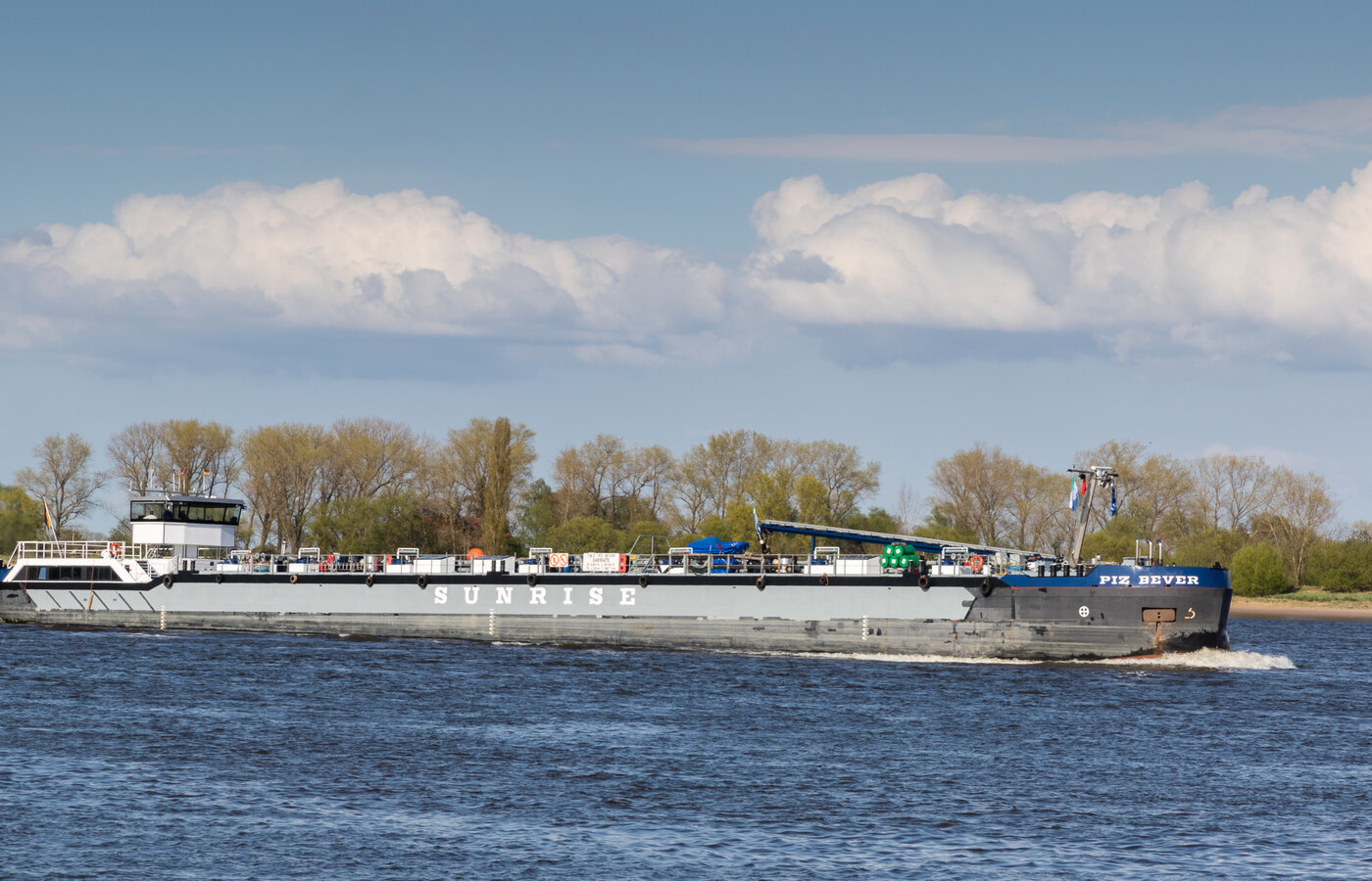 Inland waterway chemical tank barge moored at Belgian port quay